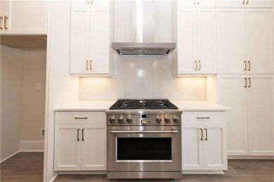 Kitchen boasts sleek stainless steel appliances, i