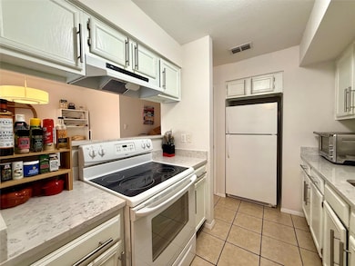 Kitchen featuring visible vents, under cabinet ra