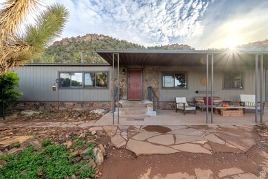 Manufactured / mobile home featuring a mountain view, a patio area, and a fire pit