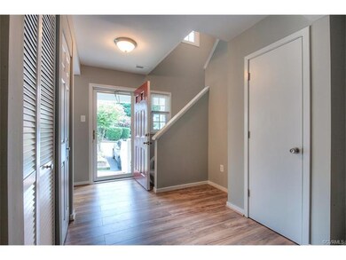 Welcoming foyer with new flooring, fresh paint, an