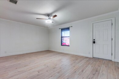Living room with ceiling fan, light wood-type floo