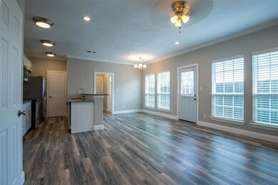 Kitchen featuring ceiling fan with notable chandelier, sink, white cabinetry, crown molding, and dark hardwood / wood-style floors