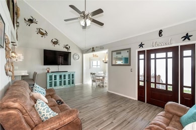 Living room with ceramic tile, high vaulted ceilin