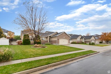View of front of house with driveway, brick siding, an attached garage, and a residential view