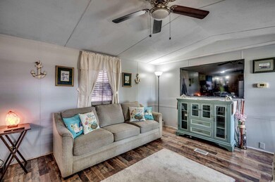 Living room with vaulted ceiling, wood-type floori