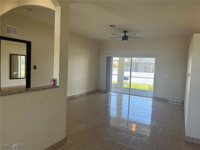 Empty room with a ceiling fan, baseboards, arched