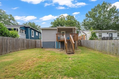 Back of property featuring stairs, a wooden deck,