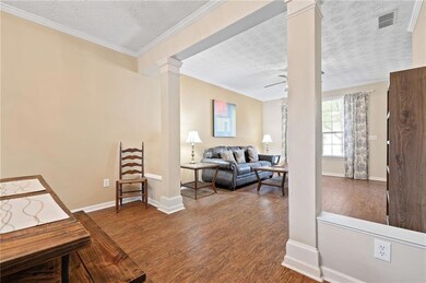 Living area with decorative columns, a textured ce