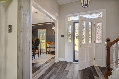 Foyer entrance with dark hardwood / wood-style flo