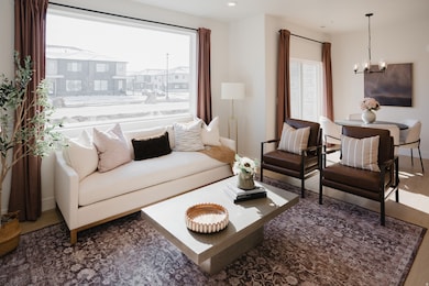 Living room featuring dark wood finished floors and a chandelier