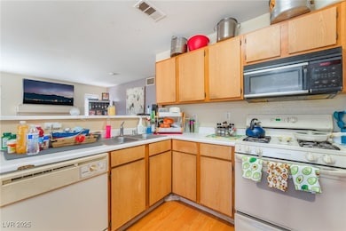 Unit A Kitchen with white appliances, light counte