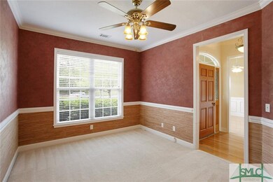Separate living room or study has crown molding, c