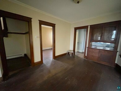 Interior space with a baseboard radiator, dark har