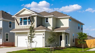 View of front facade featuring a garage, concrete