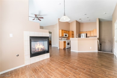 Unfurnished living room featuring ceiling fan, hig
