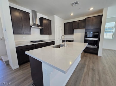 Kitchen with visible vents, wall chimney exhaust h