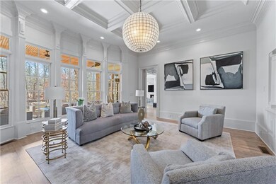 Living area with an inviting chandelier, crown mol