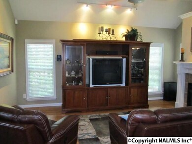 Enjoy family time in the Great Room with vaulted ceilings, hardwoods, ceiling fan, gas log fireplace, and opens to Kitchen.