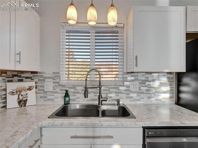 Kitchen featuring white cabinets, pendant lighting