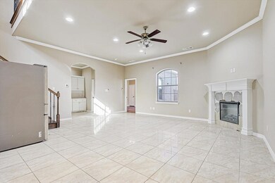 Unfurnished living room with ceiling fan and ornam