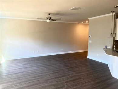 Living room featuring ornamental molding, ceiling fan, baseboards, dark wood-style flooring, and recessed lighting.