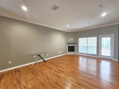 Unfurnished living room featuring light hardwood / wood-style flooring and crown molding