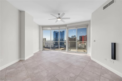 Empty room featuring visible vents, a view of city