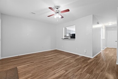 Spare room with ceiling fan, baseboards, and wood