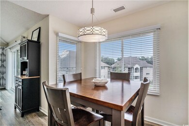 Dining room featuring wood finished floors and a textured ceiling