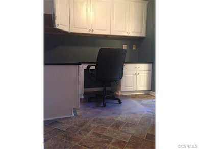 Office with built in desk and book case with grani