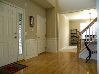 Entry. Elegant picture frame wainscoting in the entry. Notice the side light windows.