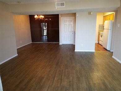 Empty room with visible vents, baseboards, dark wo