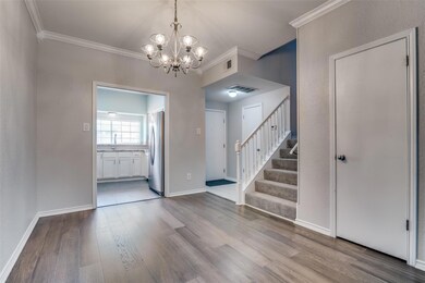 Foyer entrance featuring light wood flooring, chan