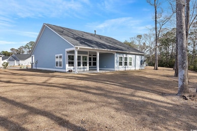 Rear view of house with roof with shingles and a y