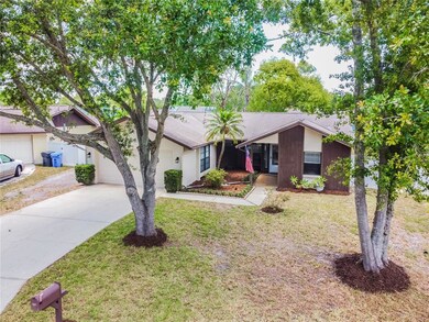 Front View with mature trees and Florida friendly 