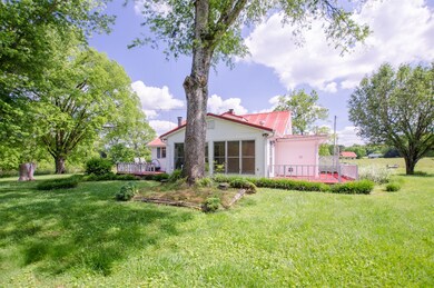 The backside of home showing Florida room