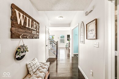 The entry way immediately showcases upgraded hand-scraped engineered hardwood flooring throughout most of the main level.  Engineered hardwood is a custom touch chosen for durability and beauty.