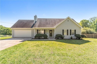 View of front of house with concrete driveway, a c