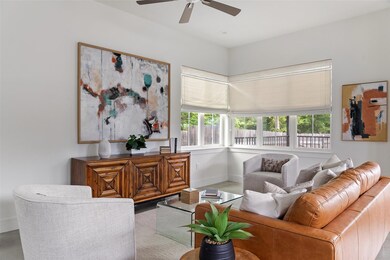 Living room featuring baseboards and a ceiling fan