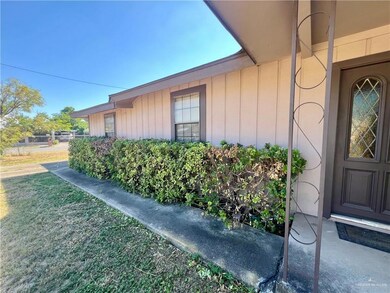 View of side of home featuring board and batten siding and a lawn