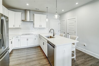 Kitchen featuring white cabinetry, stainless steel