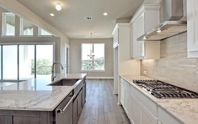 Kitchen with wall chimney range hood, appliances 