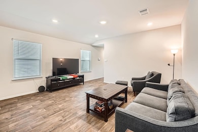 Living area with light wood finished floors, base