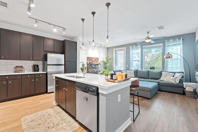 Kitchen with dark brown cabinets, a sink, stainle