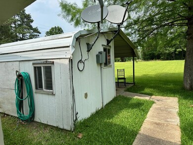 View of shed / structure featuring a lawn