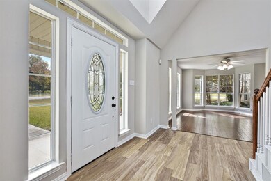 Welcoming entry way with decorative glass insert in front door.