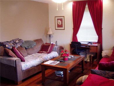 Living Room. The living room has a ceiling fan and