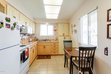 Kitchen has an eating area. Range and re