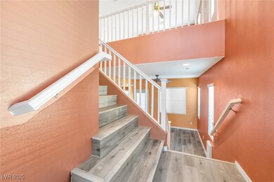 Staircase featuring a towering ceiling, wood finis