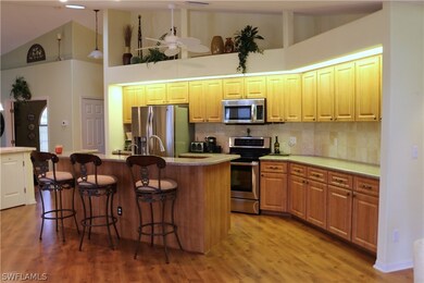 Beautiful kitchen. You can see the cabinets in the buffet island on the left. The floor is a high quality wood laminate, chosen for the comfortable effect on legs and feet. In the center is a pantry. That hallway leads to laundry room and garage.